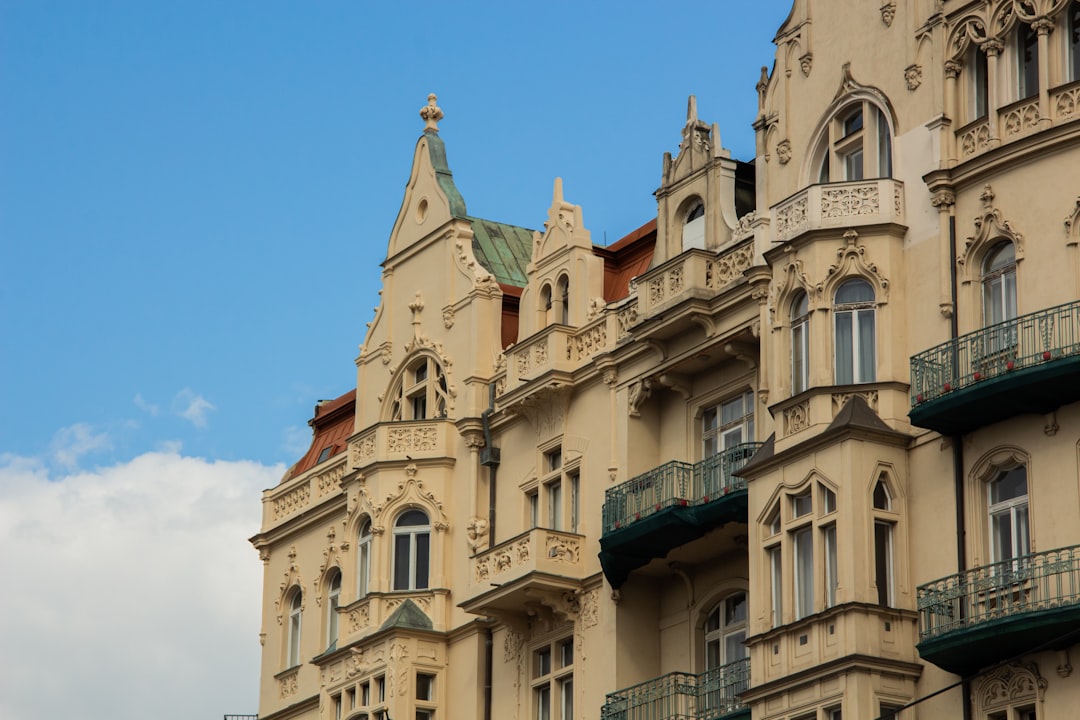 ornate-building-facade-against-a-blue-sky-pm3sjvabfoi